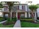 Charming townhome with well-maintained landscaping and a welcoming red front door at 3426 Wilshire Way Rd # 189, Orlando, FL 32829