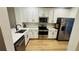 Bright kitchen with white cabinets, stainless steel appliances, and modern countertops at 3426 Wilshire Way Rd # 189, Orlando, FL 32829