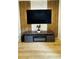 Living room with wood slat and marble accent wall, featuring a mounted TV and modern entertainment center at 3426 Wilshire Way Rd # 189, Orlando, FL 32829