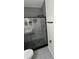 Sleek walk-in shower featuring gray tile, black fixtures, and a contemporary glass door at 3426 Wilshire Way Rd # 189, Orlando, FL 32829