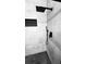 Close-up of a modern shower with a large rain shower head and stylish black fixtures against white tiling at 3426 Wilshire Way Rd # 189, Orlando, FL 32829