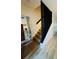 Modern staircase with wooden steps, black handrail and white walls at 3426 Wilshire Way Rd # 189, Orlando, FL 32829