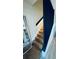 Modern staircase with wooden steps, black handrail and white walls at 3426 Wilshire Way Rd # 189, Orlando, FL 32829
