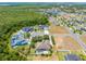 Aerial view of a home with a private pool and a well-manicured yard in a quiet neighborhood at 3551 Buckingham Ct, St Cloud, FL 34772