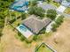 Backyard view of a house with a fenced-in kidney-shaped pool and lush landscaping at 3551 Buckingham Ct, St Cloud, FL 34772