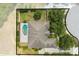 Aerial view of the backyard featuring a kidney-shaped pool, perimeter fence, and mature trees at 3551 Buckingham Ct, St Cloud, FL 34772