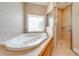 Bright bathroom featuring a luxurious soaking tub with jets and a separate shower at 3551 Buckingham Ct, St Cloud, FL 34772