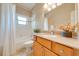 Well-lit bathroom featuring a vanity with granite countertops and a tiled shower at 3551 Buckingham Ct, St Cloud, FL 34772
