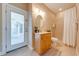 Bright bathroom featuring a glass door leading to a patio and a shower with neutral toned tiles at 3551 Buckingham Ct, St Cloud, FL 34772