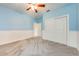A charming bedroom with light blue walls, white wainscoting, and a ceiling fan at 3551 Buckingham Ct, St Cloud, FL 34772