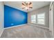 A bright bedroom with blue walls, gray accents, and dual windows providing ample light at 3551 Buckingham Ct, St Cloud, FL 34772