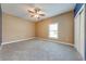 Spacious bedroom with neutral carpet, a ceiling fan, and a bright window at 3551 Buckingham Ct, St Cloud, FL 34772