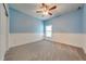 This bedroom features light blue walls, white wainscoting, and a ceiling fan at 3551 Buckingham Ct, St Cloud, FL 34772
