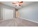 Bedroom with light gray walls, carpet flooring, and a sliding door closet at 3551 Buckingham Ct, St Cloud, FL 34772
