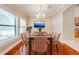 Formal dining room with hardwood floors, chandelier, and large windows at 3551 Buckingham Ct, St Cloud, FL 34772