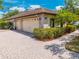 Spacious paved driveway leading to a three-car garage with an attractively landscaped yard at 3551 Buckingham Ct, St Cloud, FL 34772