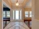 Elegant foyer with tile flooring that creates a seamless transition between rooms and a clear front door at 3551 Buckingham Ct, St Cloud, FL 34772