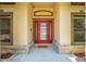 Inviting front entryway with a red door and decorative brick accents, with a 'welcome' doormat at 3551 Buckingham Ct, St Cloud, FL 34772