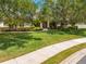 Charming single-Gathering home with a well-manicured lawn and lush landscaping and a red front door at 3551 Buckingham Ct, St Cloud, FL 34772