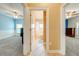 Hallway connecting bedrooms and bathroom with tile flooring and neutral paint at 3551 Buckingham Ct, St Cloud, FL 34772