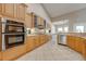 Well-equipped kitchen featuring wooden cabinets, stainless steel appliances, and a cozy breakfast nook at 3551 Buckingham Ct, St Cloud, FL 34772