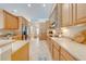 Bright kitchen boasts stainless steel appliances, granite counters, and lots of wood cabinets at 3551 Buckingham Ct, St Cloud, FL 34772