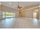 Bright, open living room with vaulted ceilings, neutral tones, and access to the outdoor patio at 3551 Buckingham Ct, St Cloud, FL 34772