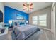 Beautifully decorated main bedroom featuring blue accents, plush bedding, and a modern aesthetic at 3551 Buckingham Ct, St Cloud, FL 34772
