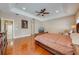 Large main bedroom featuring hardwood floors, tray ceilings, and recessed lighting at 3551 Buckingham Ct, St Cloud, FL 34772
