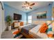Cozy main bedroom with an accent wall, comfortable bed, and a modern dresser at 3551 Buckingham Ct, St Cloud, FL 34772