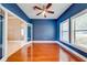 Office with hardwood flooring, blue walls, and an adjacent room at 3551 Buckingham Ct, St Cloud, FL 34772