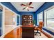 Bright office featuring hardwood floors, a built-in bookcase, and large windows at 3551 Buckingham Ct, St Cloud, FL 34772