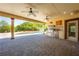 This outdoor patio features a custom kitchen with a grill, mini-fridge, and ample space for entertaining by the pool at 3551 Buckingham Ct, St Cloud, FL 34772