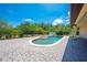 Inviting pool with a small water feature surrounded by a brick patio, perfect for outdoor relaxation and entertainment at 3551 Buckingham Ct, St Cloud, FL 34772