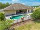 Beautiful backyard with a refreshing pool, outdoor patio, and lush landscaping at 3551 Buckingham Ct, St Cloud, FL 34772