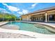 Beautiful backyard pool with a fountain, surrounded by a brick patio and the home's covered outdoor living area at 3551 Buckingham Ct, St Cloud, FL 34772
