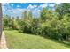 Lush backyard landscaping with privacy hedges, offering a serene outdoor space at 3881 Wind Dancer Cir, St Cloud, FL 34772
