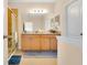 Bathroom featuring a double vanity, a large mirror, and a tiled walk-in shower at 3881 Wind Dancer Cir, St Cloud, FL 34772