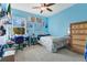 Comfortable bedroom featuring a ceiling fan, window with natural light and colorful decor at 3881 Wind Dancer Cir, St Cloud, FL 34772