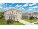 Charming two-story home featuring a well-manicured lawn, driveway, and inviting curb appeal at 3881 Wind Dancer Cir, St Cloud, FL 34772