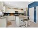 Kitchen featuring white cabinets, stainless steel appliances, a center island with seating, and stylish decor at 3881 Wind Dancer Cir, St Cloud, FL 34772