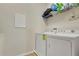 Well-equipped laundry room featuring a washer, dryer and overhead shelving at 3881 Wind Dancer Cir, St Cloud, FL 34772
