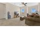 Spacious living room with neutral carpet, ceiling fan, and bright windows at 3881 Wind Dancer Cir, St Cloud, FL 34772