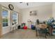 Bright home office with modern decor, a large window, and a wood desk at 3881 Wind Dancer Cir, St Cloud, FL 34772