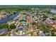 Wide angle aerial view of property surrounded by lush greenery, water, and other residential homes at 404 N Sundance Dr, Lake Mary, FL 32746