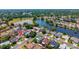 Aerial view of a home nestled in a neighborhood with lush trees and a serene pond at 404 N Sundance Dr, Lake Mary, FL 32746