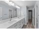 Bright bathroom featuring a double vanity with white countertops and modern fixtures, plus stylish lighting at 404 N Sundance Dr, Lake Mary, FL 32746
