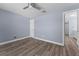 Light blue bedroom features a ceiling fan, and wood flooring at 404 N Sundance Dr, Lake Mary, FL 32746
