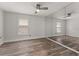Spacious bedroom featuring wood-look flooring, a ceiling fan, and a mirrored wall at 404 N Sundance Dr, Lake Mary, FL 32746
