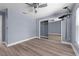 Bedroom with wood-look floors, ceiling fan and closet with mirrored doors at 404 N Sundance Dr, Lake Mary, FL 32746